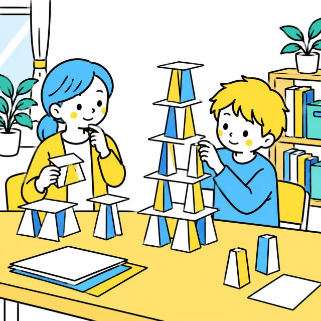 別の日の紙の塔づくりで、支え方を一つずつ変えて考える子どもたち