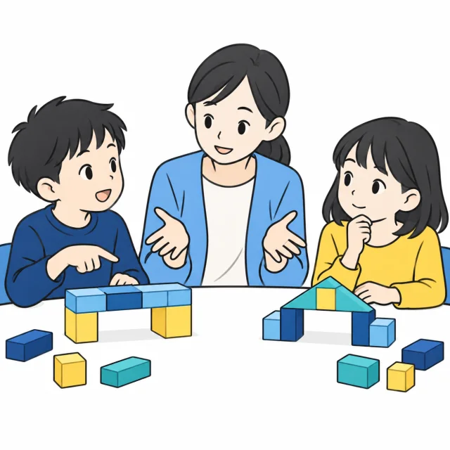 二人の子どもが工作の考えを話し、スタッフが目線を合わせて聞くイメージ